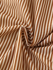Close-up of brown and white striped fabric texture with soft folds and high-quality weave