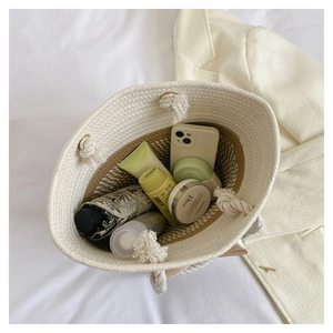 Top view of spacious woven tote bag interior showing beige and brown stitching detail