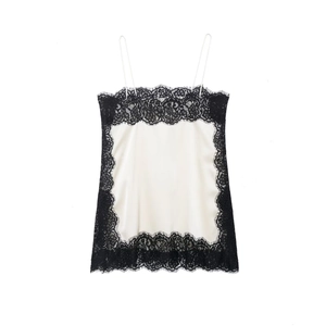 Detailed view of white silk satin camisole top with intricate black lace trimmings