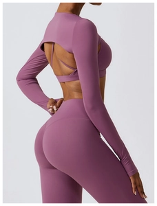 Detailed back view of purple yoga set with cross-strap bra and backless cropped top