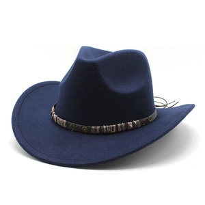 Dark blue felt cowboy hat with vintage woven band and metal gear accents on white background