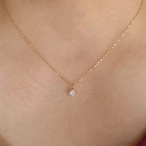 Close-up of 18K gold-plated titanium necklace with square zirconia pendant on model