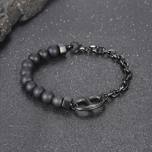 Detail of matte black beads and metal link chain bracelet with pig nose buckle
