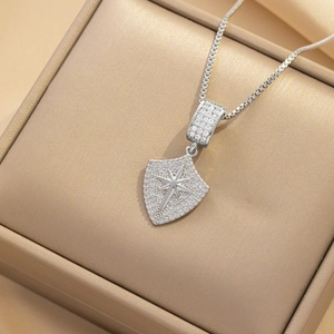Elegant shield heart necklace with sparkling crystals and star detail in a gift box