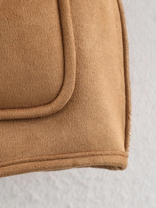 Detail shot of brown reversible jacket featuring faux suede texture and premium edge stitching