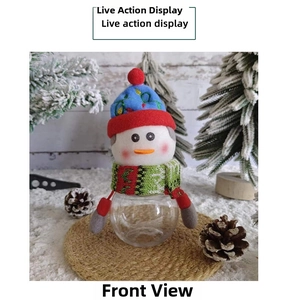 Detail of Christmas snowman candy jar with colorful knit hat on a rustic mat