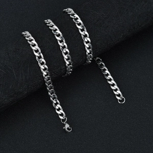 Macro shot of silver Cuban link chain with polished finish and secure lobster clasp
