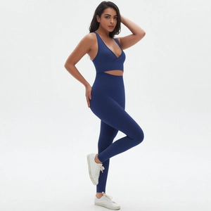 Detail of seamless dark blue yoga set with crossover V-neck sports bra and high waist leggings