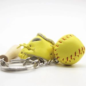 Close-up of baseball keychain with yellow leather glove, ball, and mini wooden bat