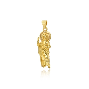 Macro shot of gold religious saint pendant with zircon inlay and relief details