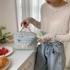 Close-up of quilted floral cotton makeup bag with light blue pattern and fabric handle