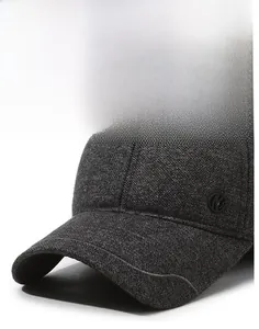 Detail of grey winter baseball cap showing thick tweed texture and protective ear flaps
