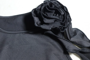 Detail of handcrafted 3D floral appliqué on a slim-fit black crop top set