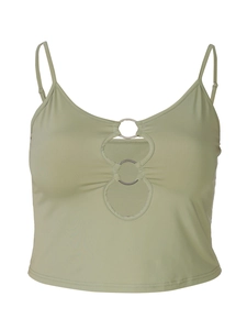 Close-up of light green crop top featuring silver metal ring connectors and cut-outs