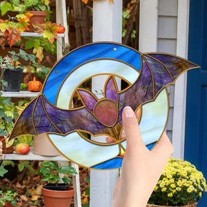 Detail of bat and moon suncatcher showing translucent acrylic texture and vibrant colors