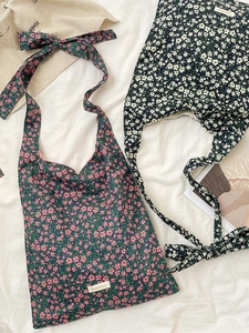 Floral canvas shoulder bags with adjustable tie straps and a minimalist aesthetic look
