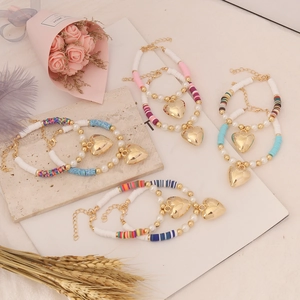 Bohemian clay beads bracelet set with faux pearls and golden heart charms in stylish colors
