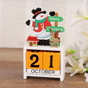 Detail of wooden snowman advent calendar with blocks on a textured tabletop