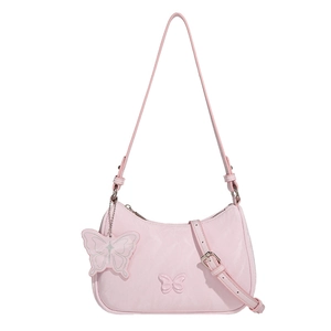 Chic pink shoulder bag with butterfly charm decoration and adjustable strap on white background