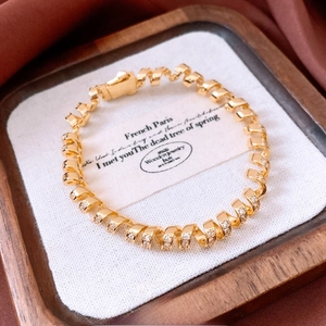 18K gold plated twisted spiral bracelet with sparkling zircon stones in a luxury finish