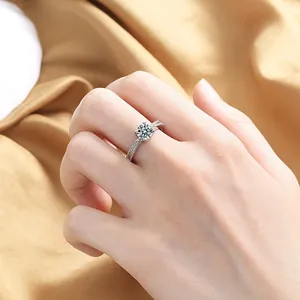 Close-up of sparkling round-cut zircon ring with twisted pavé band on silk background