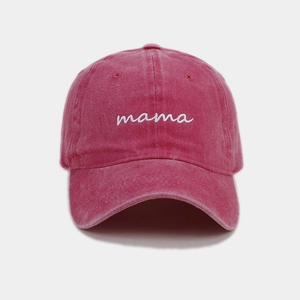 Détail de la broderie mama blanche sur casquette en coton délavé avec texture du tissu