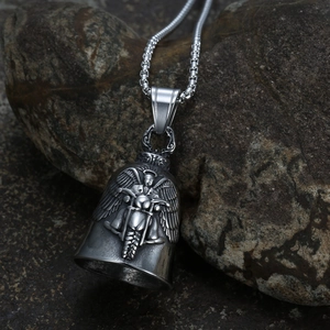 Macro view of stainless steel guardian bell pendant with embossed winged motorcycle rider