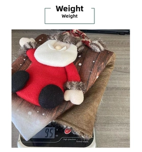 Detailed close-up of a Christmas stocking with Santa Claus doll showing 95g weight on scale