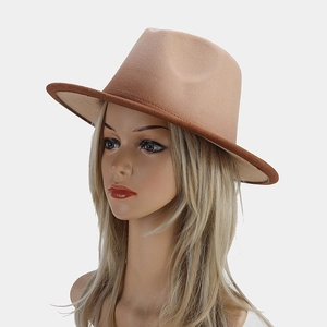 Detail view of khaki felt fedora with dark brown leather brim binding on model
