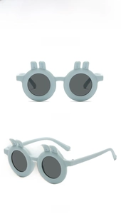 Detail view of round blue rabbit ear sunglasses for kids with grey lenses