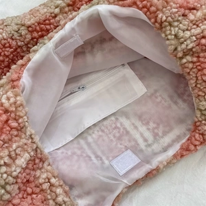 Detail of winter plaid tote bag with fluffy teddy fleece texture and inner zip pocket