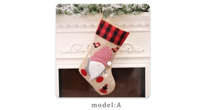 Close-up of burlap Christmas stocking with gnome applique on a festive white mantel