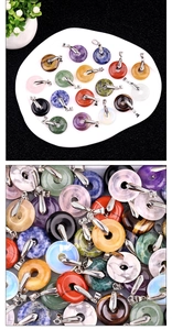 Detailed view of colorful round crystal gemstone donut pendants with silver metal clasps