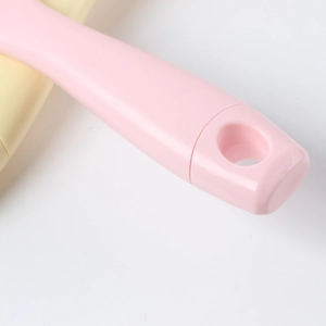 Ergonomic pink hair vent brush with curved handle and hanging hole for easy storage