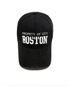 Detailed top view of black cotton baseball cap with white Boston embroidery and distressed brim