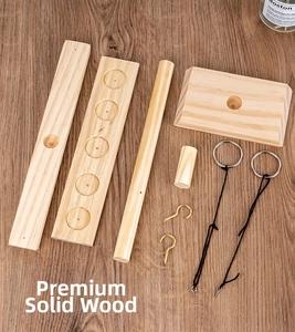 Disassembled parts of wooden ring toss game including pine boards and metal hooks