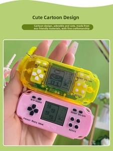 Close-up of handheld mini Tetris game console keychain featuring pink and yellow designs