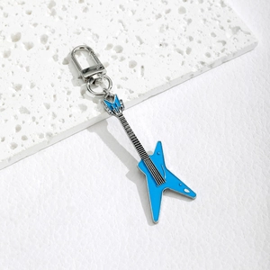 Blue electric guitar keychain made of enamel and metal on a minimalist white texture