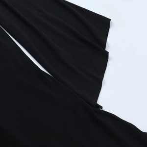 Detailed macro shot of the black fabric showing the soft drape and tight knitted texture