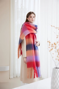 Close-up of thick winter scarf with colorful plaid pattern and long fringe details