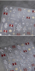 Detail of 3D Christmas nail stickers with embossed bow, golden snowflakes and stars