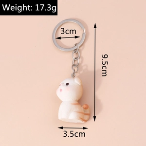 Detail view of a cartoon cat acrylic keychain showing 17.3g weight and 9.5cm dimensions