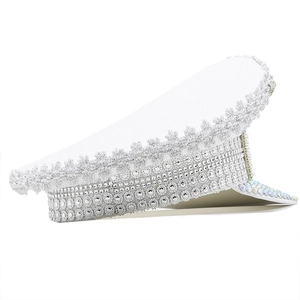Detail of white military party hat with silver lace trim and iridescent rhinestones