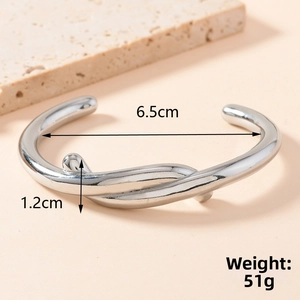 Detail shot of irregular stainless steel cuff bangle with 6.5cm diameter measurements