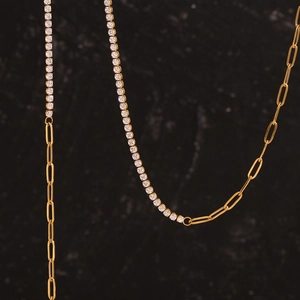 Detailed close-up of 18K gold plated paperclip chain and sparkling zircon tennis necklace