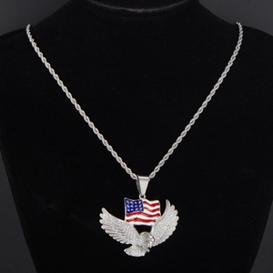 Detail of silver eagle pendant with American flag enamel on a black velvet stand