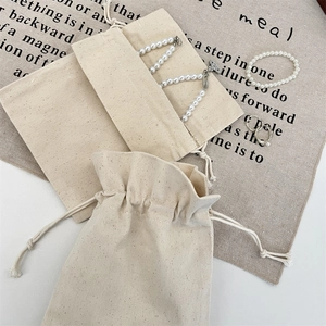 Beige cotton linen drawstring pouch set showing open and closed storage styles