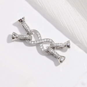 Macro shot of silver 8-shape jewelry clasp connector with sparkling cubic zirconia inlay