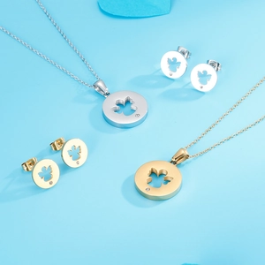 Detail of gold and silver necklace sets featuring hollow angel pendants with small diamonds