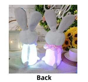 Detail of plush glowing bunnies with LED light effects and pink lace neck ribbons
